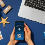 Image: A mobile device displaying Travel Budget Apps for convenient booking, featuring a Christmas travel concept with a laptop in the background.