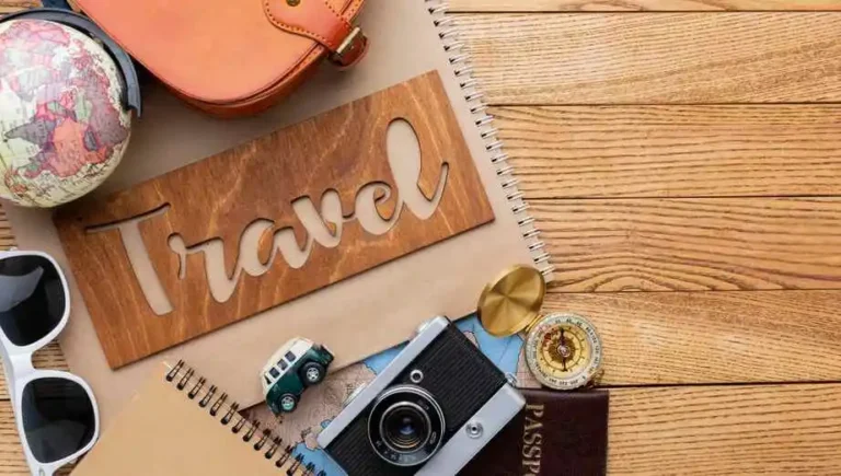 Layover Travel Tips - A collection of essential travel items neatly arranged on a wooden background.