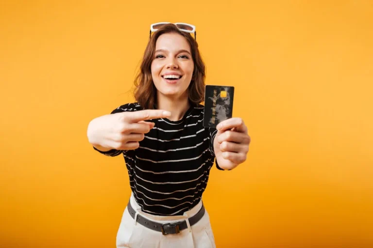 Excited girl pointing finger at a credit card - Travel Rewards Credit Cards concept